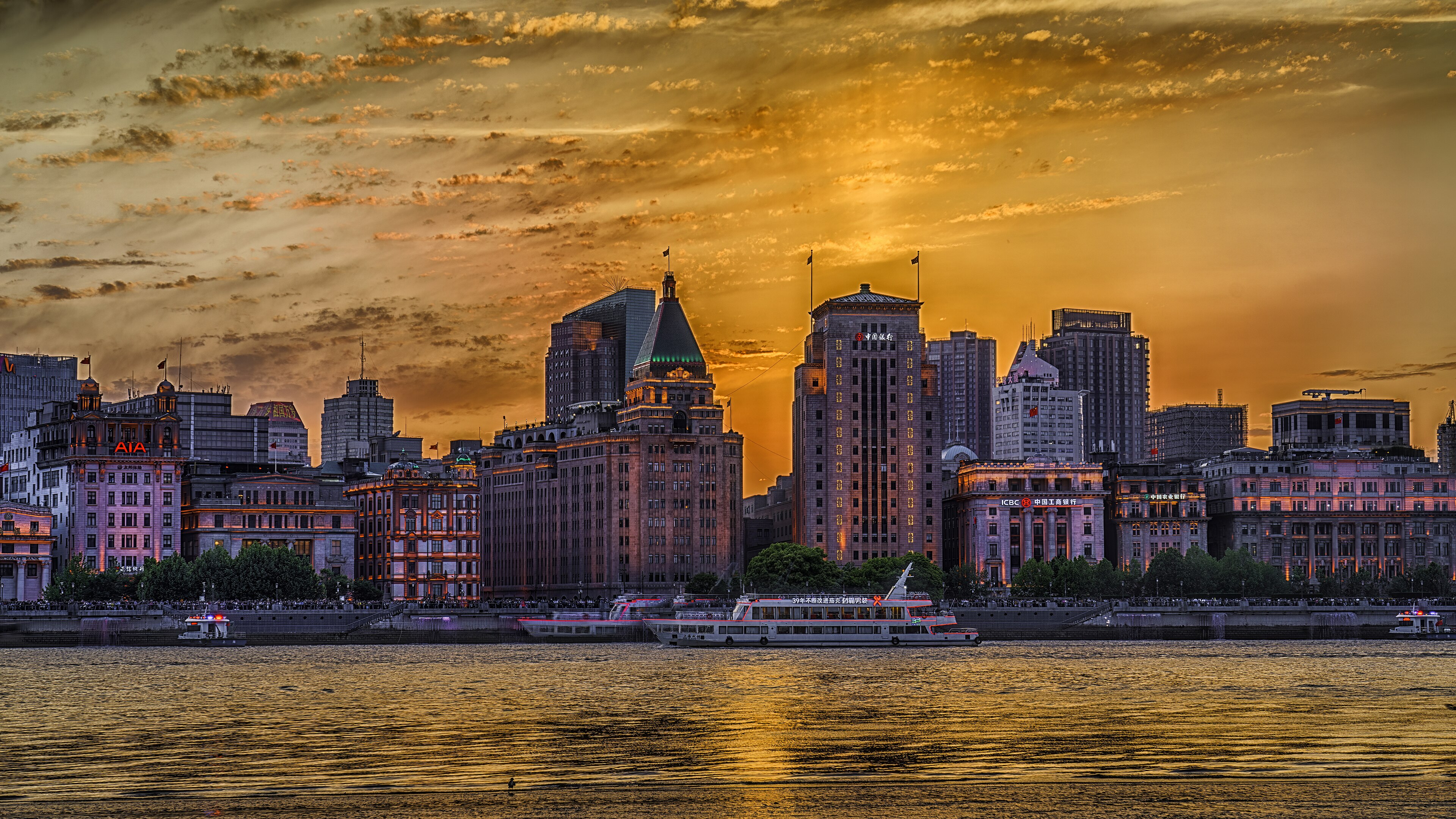 A city skyline in China at sunset across a river
